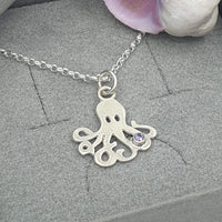 octopus with purple stone necklace