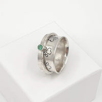 paw print and emerald spinner ring