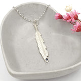 feather necklace with blue sapphire gemstone